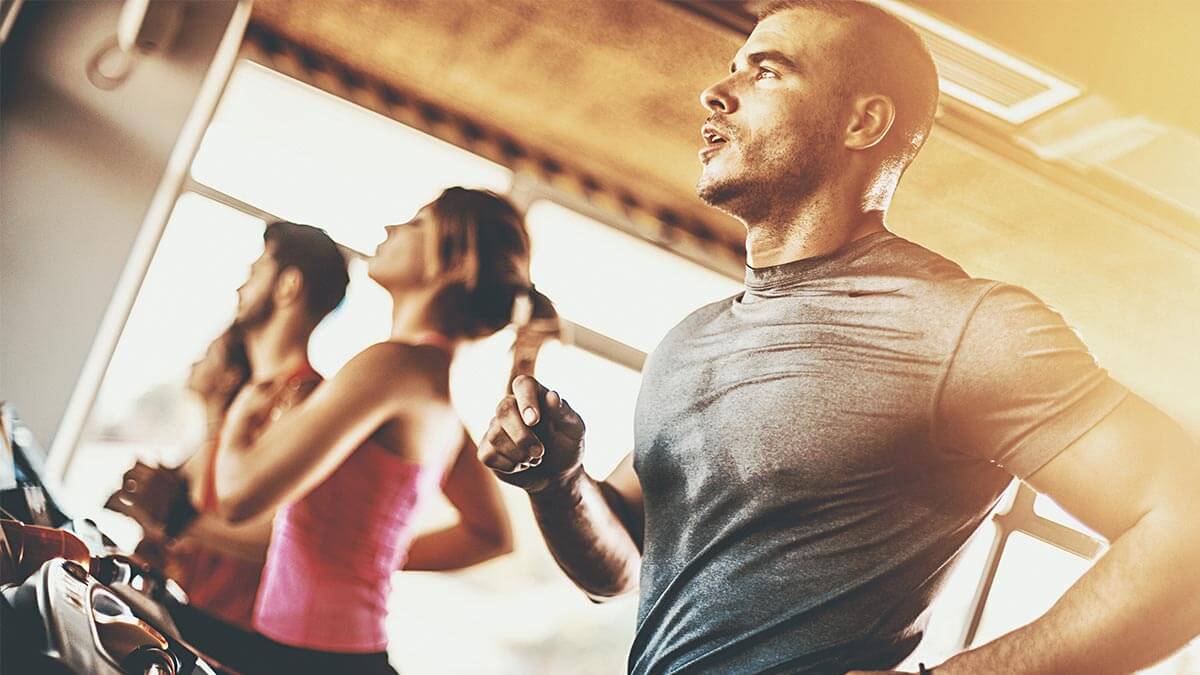 people running on treadmills at gym