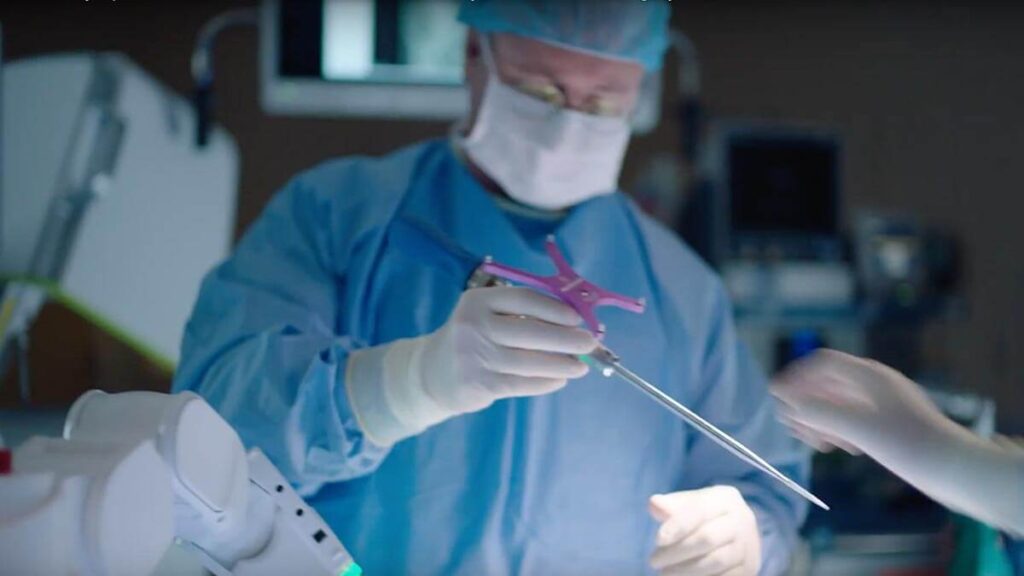 Surgeon handing over tool during surgery