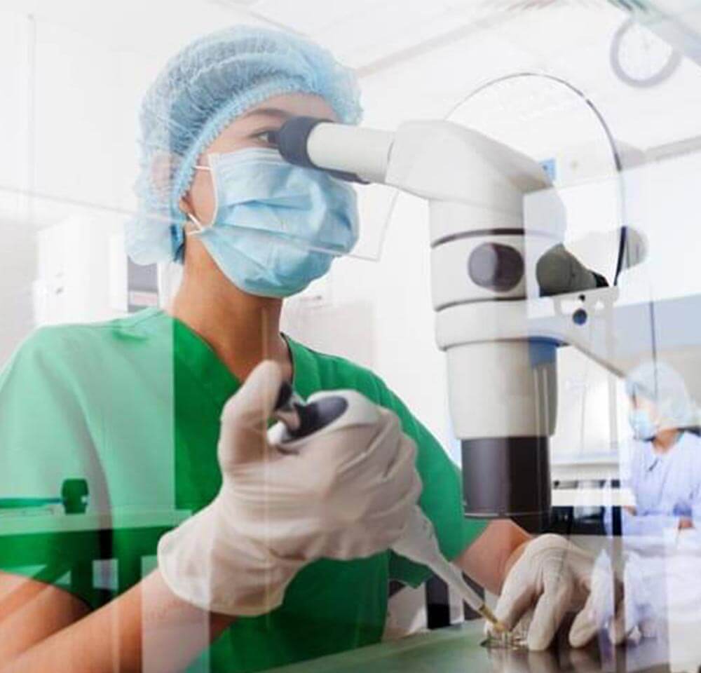 research doctor looking in microscope