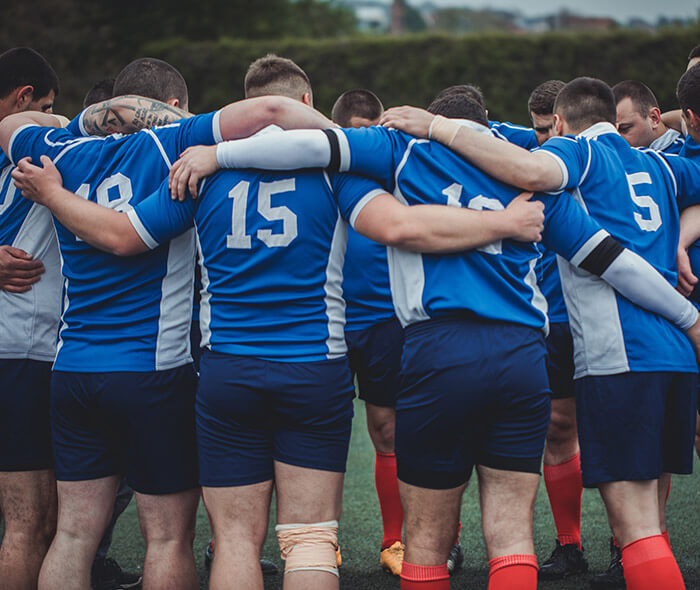 Mens sports team huddle