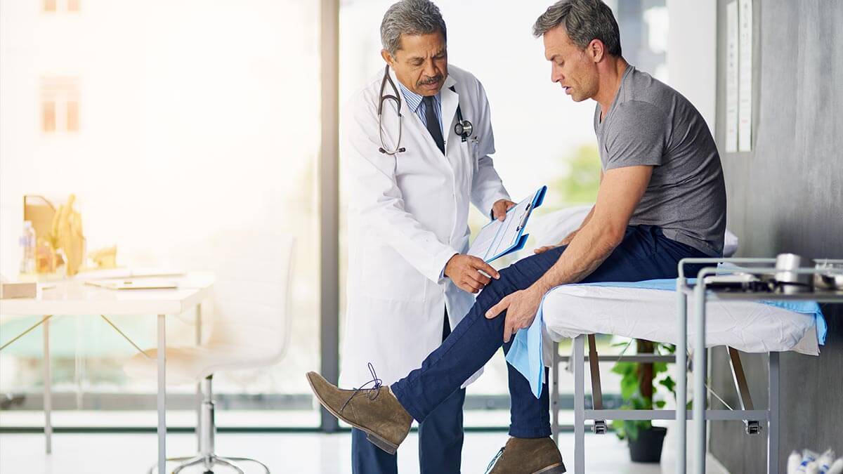 doctor examining patient's knee joint